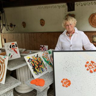 Giovanna Pasello mostra una delle sue opere che saranno esposte a Porto Ceresio da sabato al 9 agosto