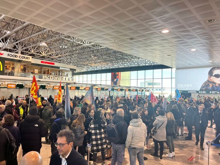A Malpensa la protesta dei lavoratori tra i passeggeri: «Con il cambio di appalto a rischio i nostri diritti»