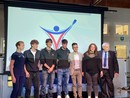 I ragazzi dell'Istituto Falcone con alle spalle il logo da loro disegnato